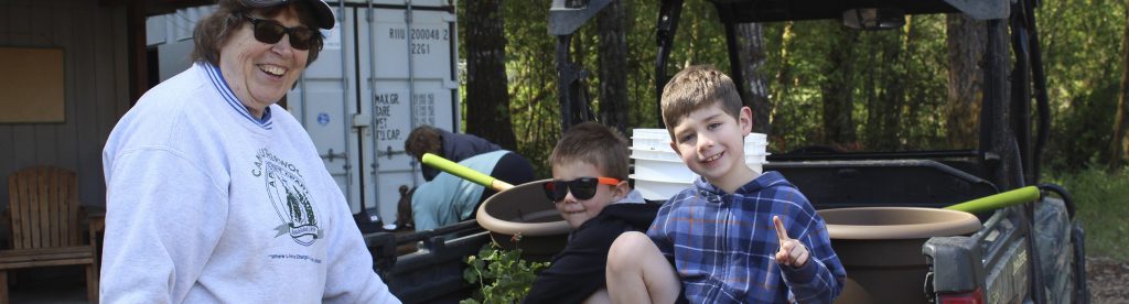 A woman and two young boys volunteering to work on the site crew at Camp Lutherwood Oregon