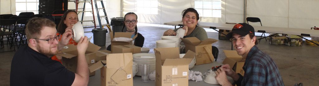 A group of five volunteers preparing new dishes for Camp Lutherwood Oregon