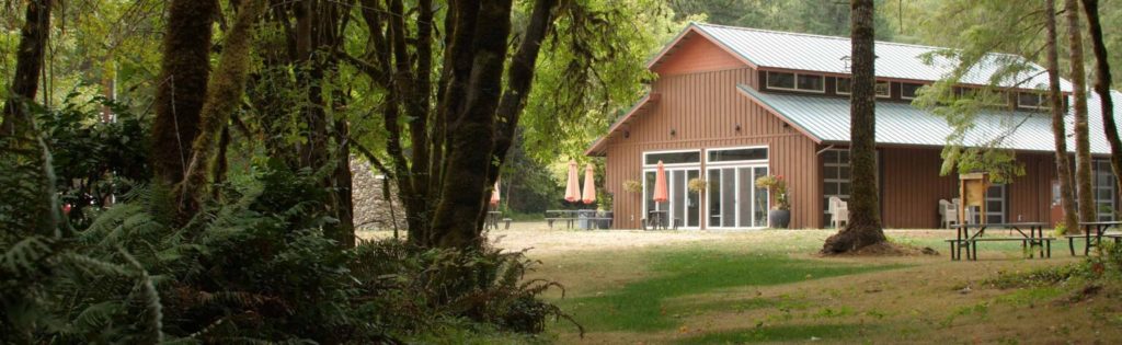 The dining hall with the patio and picnic tables in the foreground at Camp Lutherwood Oregon