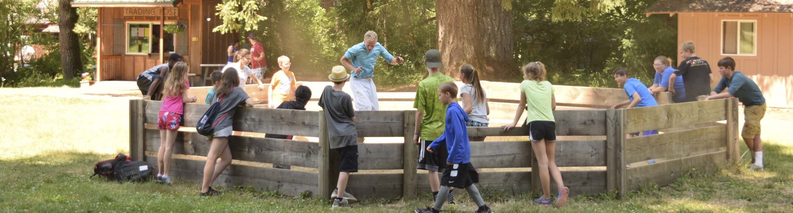 Middle school campers playing gaga ball with their counselor