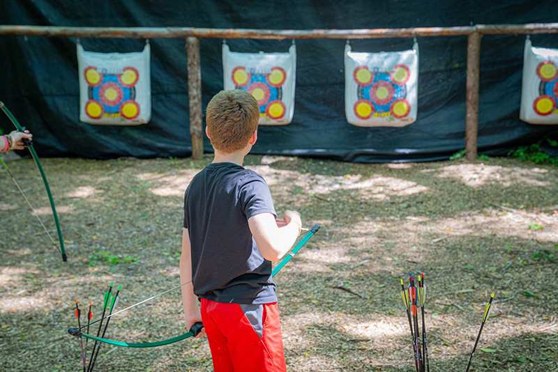 A camper practicing archery